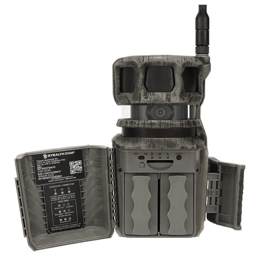 Stealth Cam trail camera with open battery compartments and side panel, featuring antenna