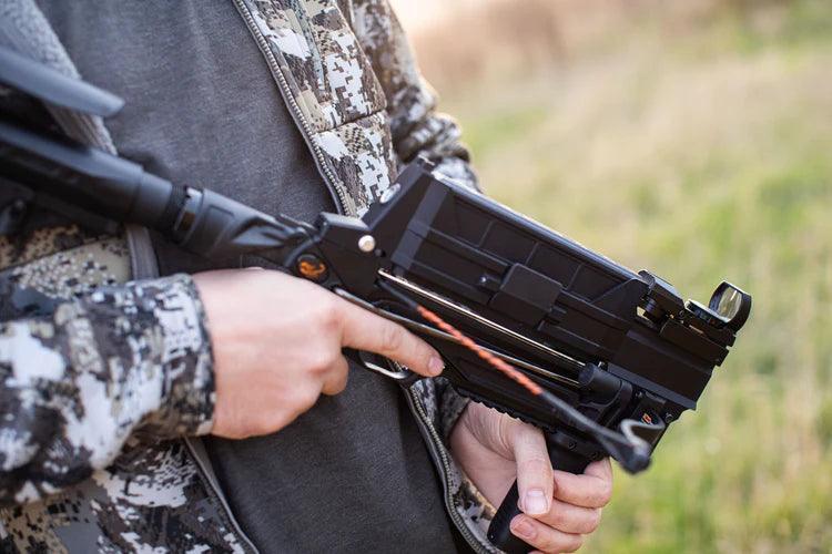 Person holding Steambow AR series M10 crossbow outdoors in camo jacket