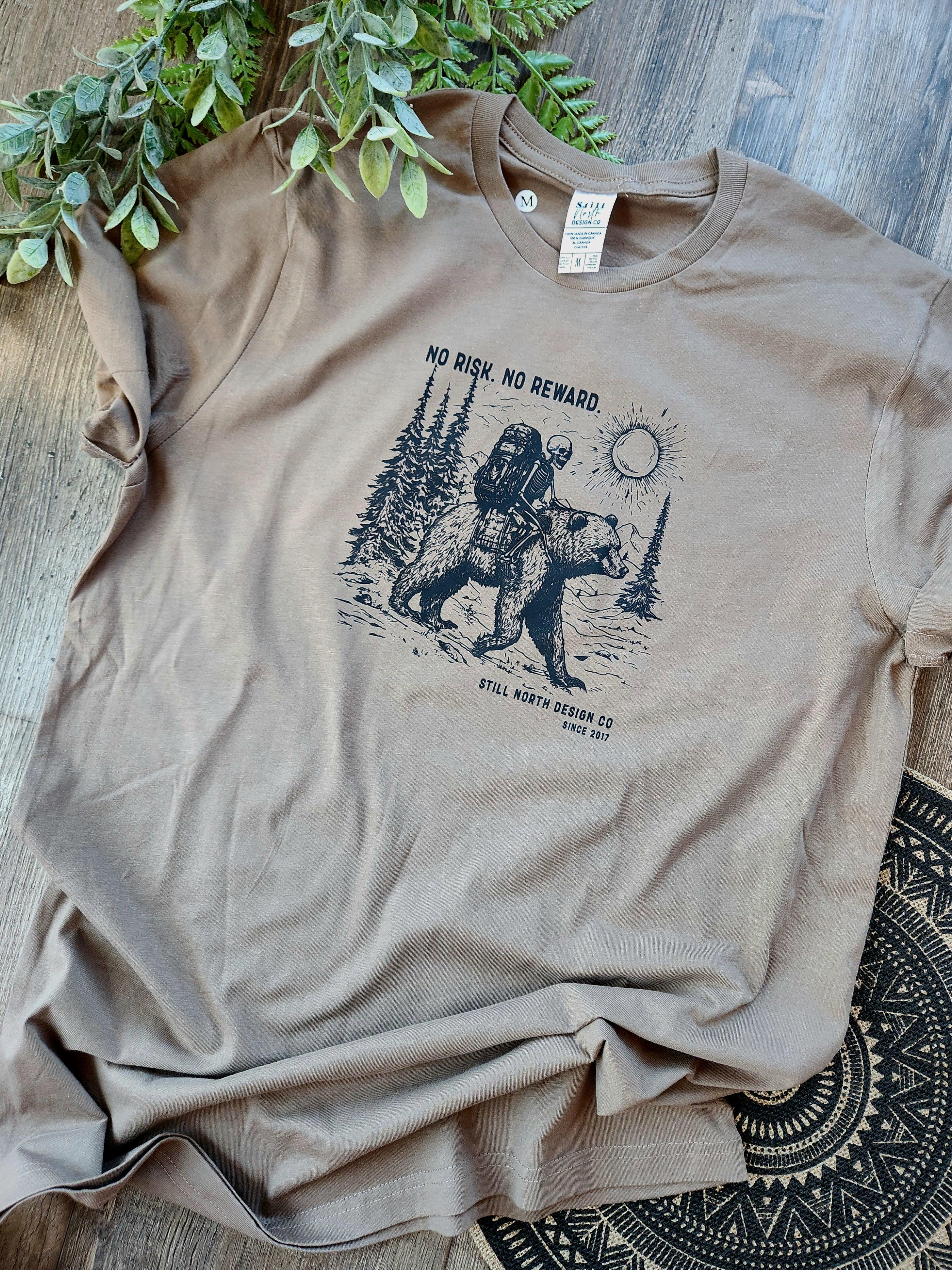 Brown graphic t-shirt with hiker and bear design, 'No Risk. No Reward.' rustic style
