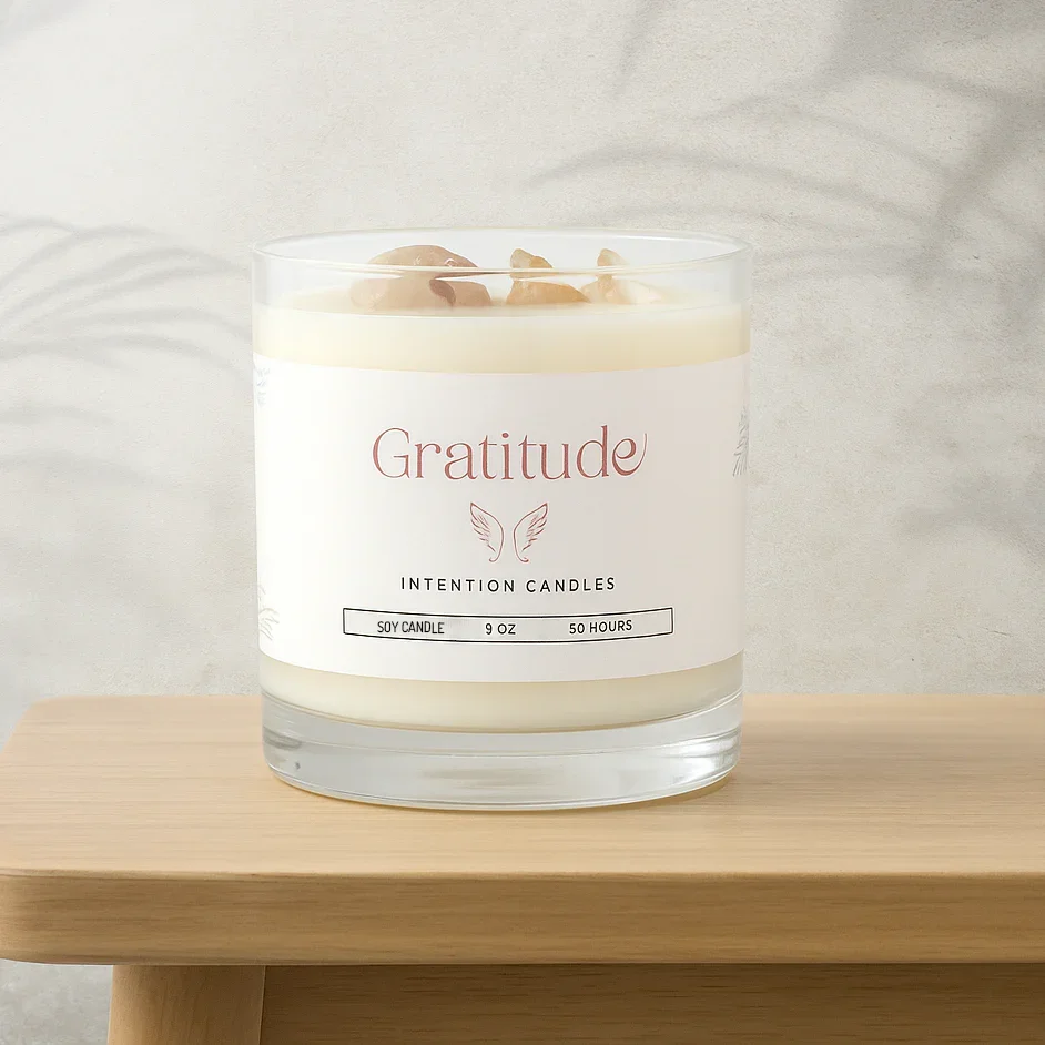 Gratitude soy intention candle in glass jar with crystal stones on wooden surface