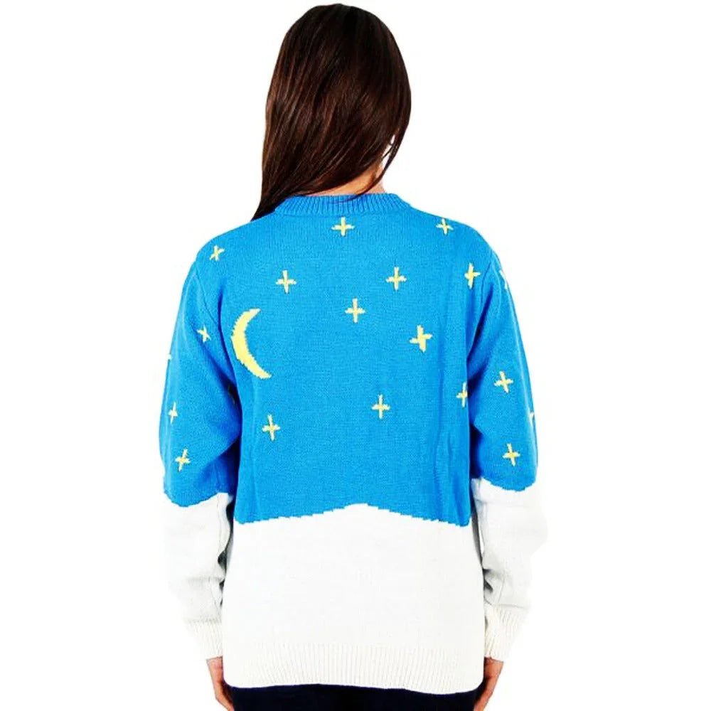 Woman wearing blue and white Christmas sweater with yellow moon and star patterns on the back