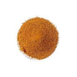 Pile of orange-brown seasoning powder on white background spice blend