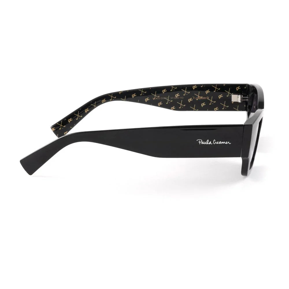 Black sunglasses with wide arms, gold pattern inside, and Paula Creamer logo on the side