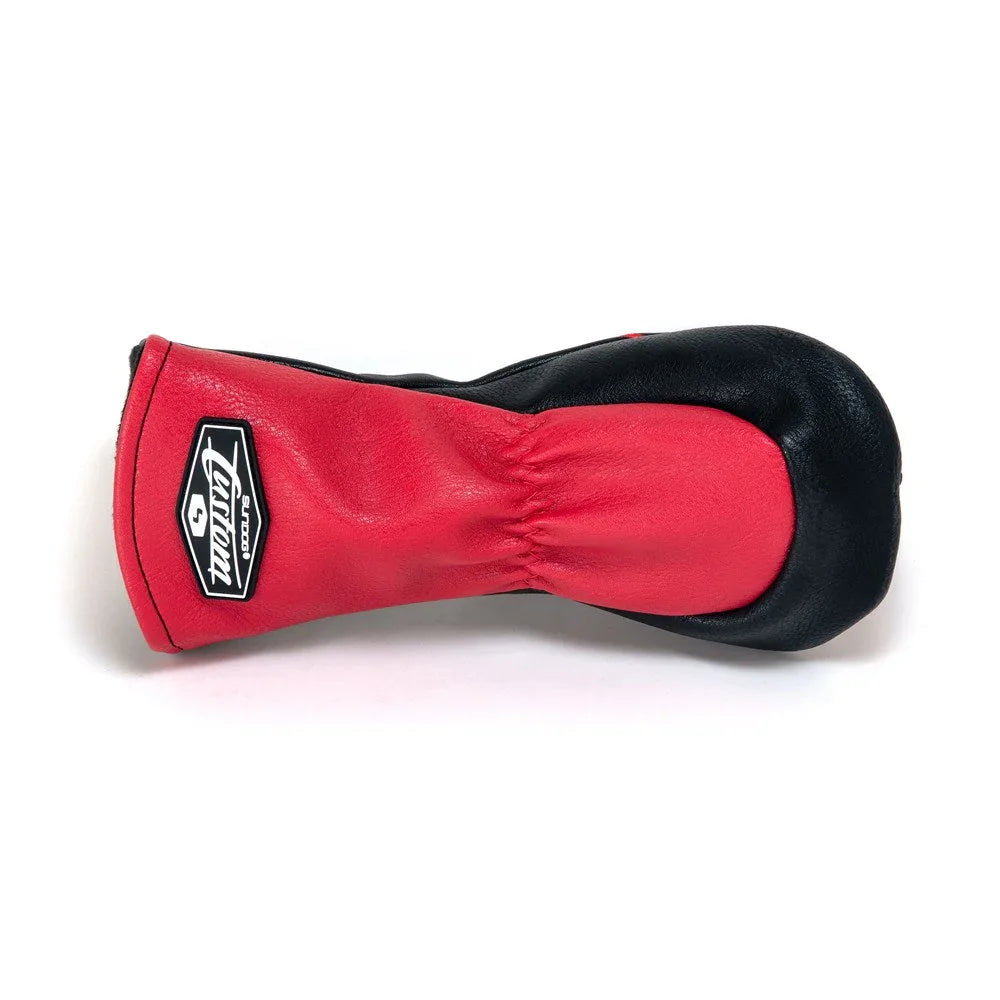 Red and black leather golf driver headcover with logo patch on white background