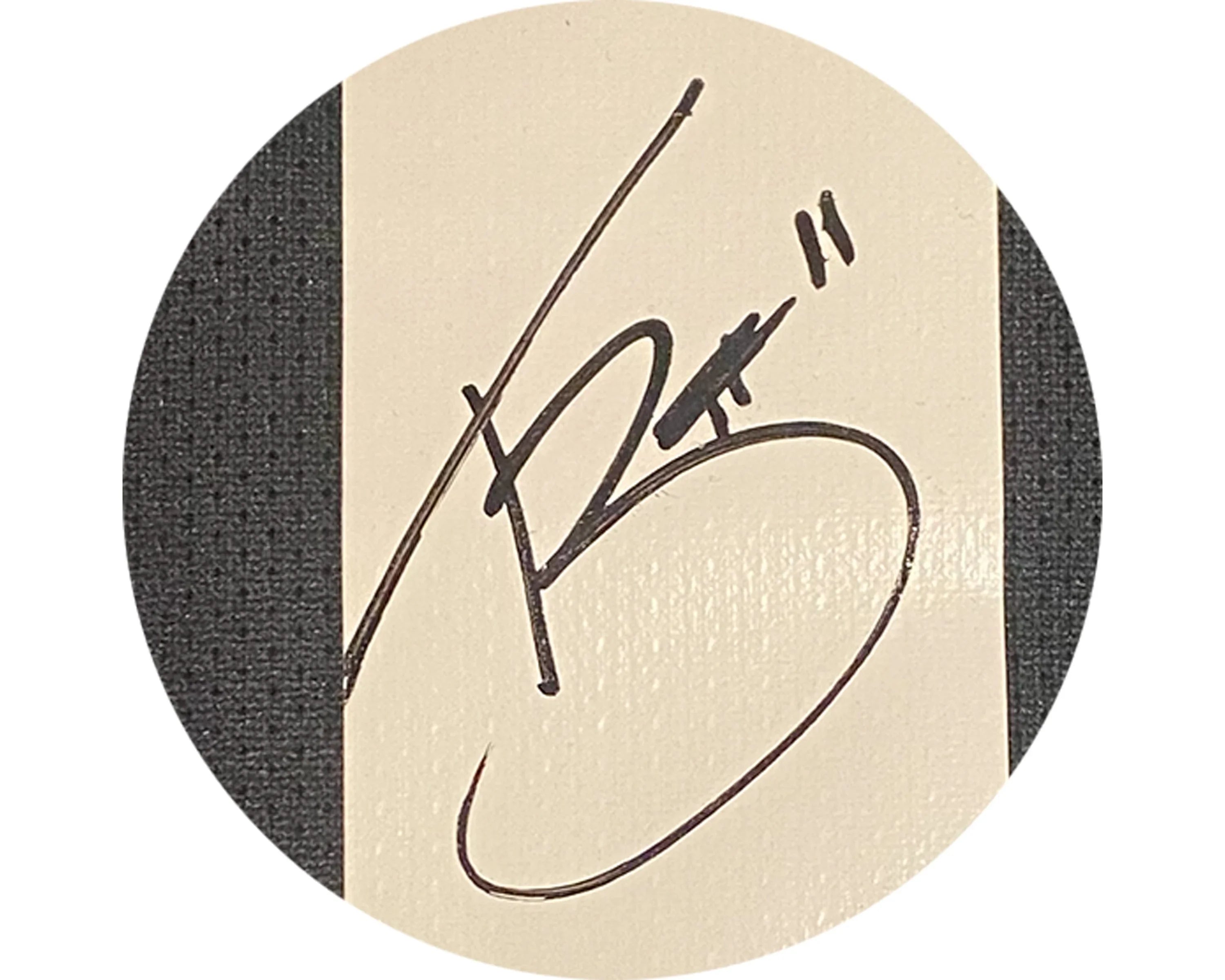 Black marker autograph with number 11 on a beige card, close-up detail