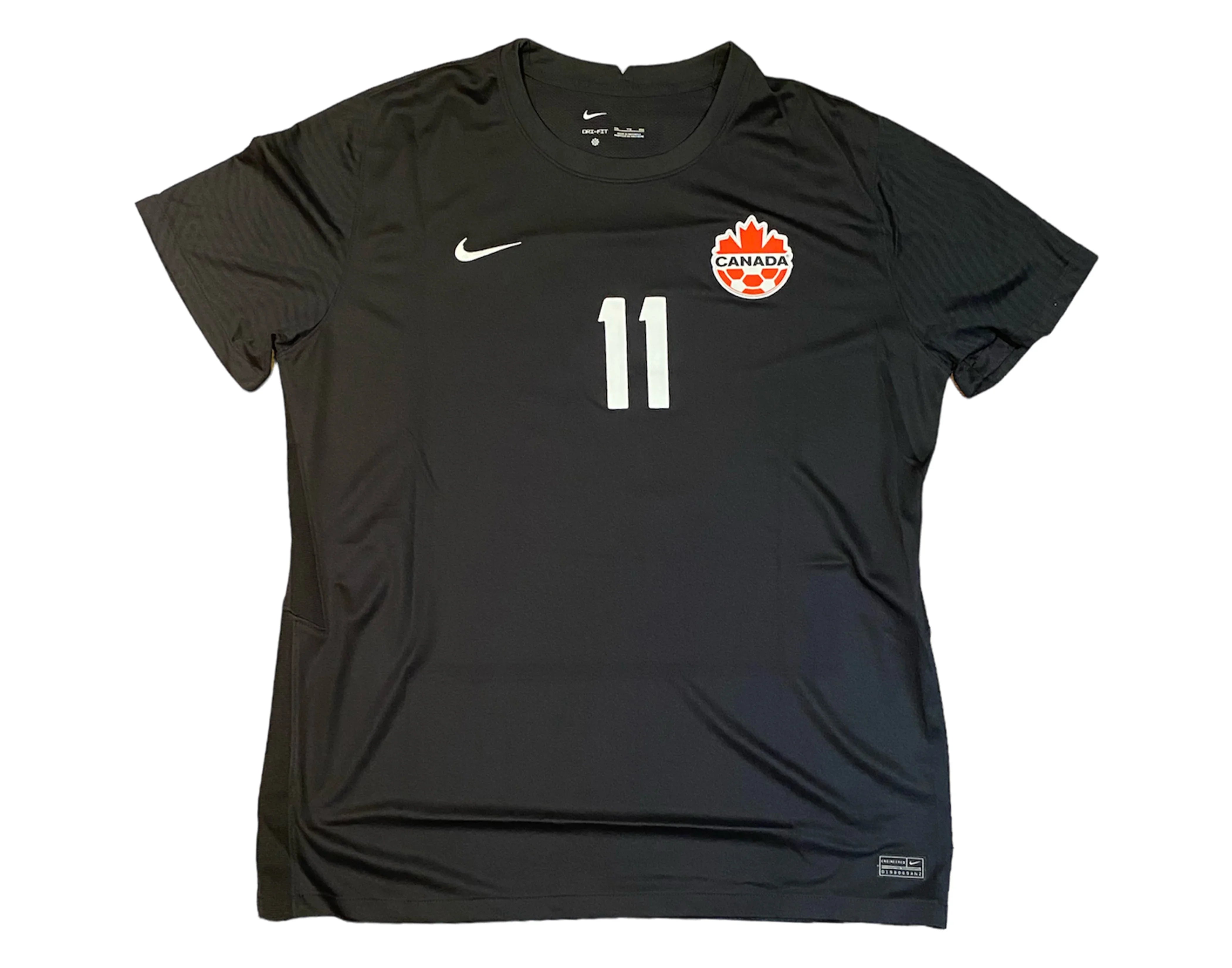 Black Canada soccer jersey with number 11, Nike logo, and Canada soccer crest.