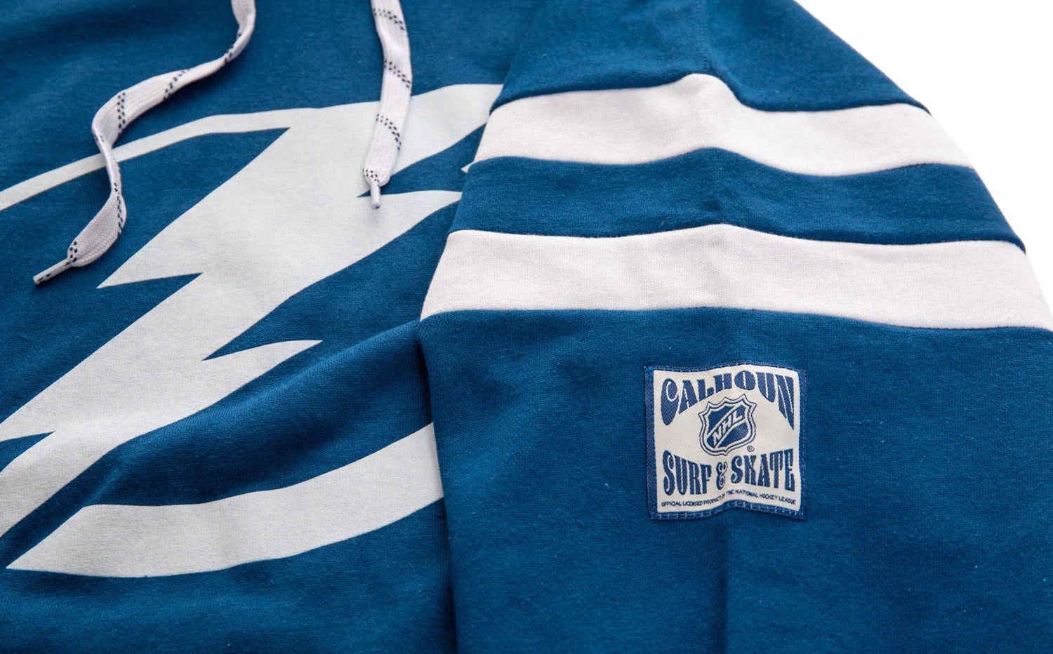 Blue Tampa Varsity hoodie with white lightning bolt, striped sleeve, and Calhoun NHL patch