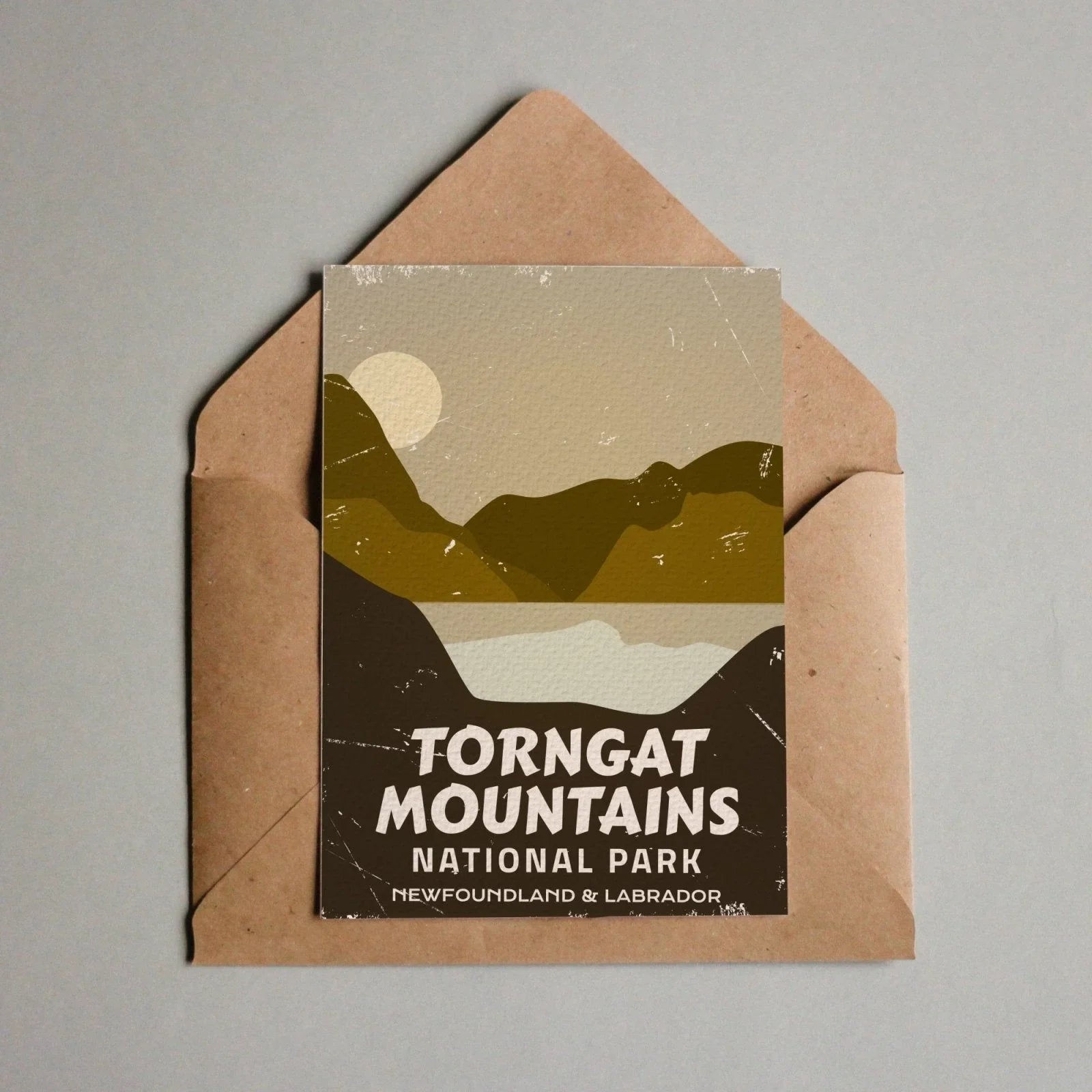 Torngat Mountains National Park postcard with stylized mountains, sun, and brown envelope