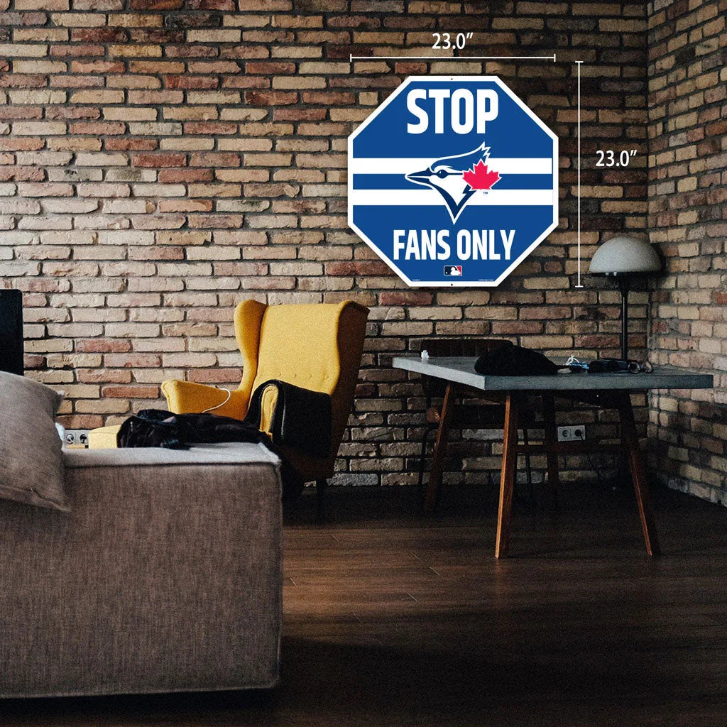 Toronto Blue Jays STOP Fans Only sign on brick wall in modern living room