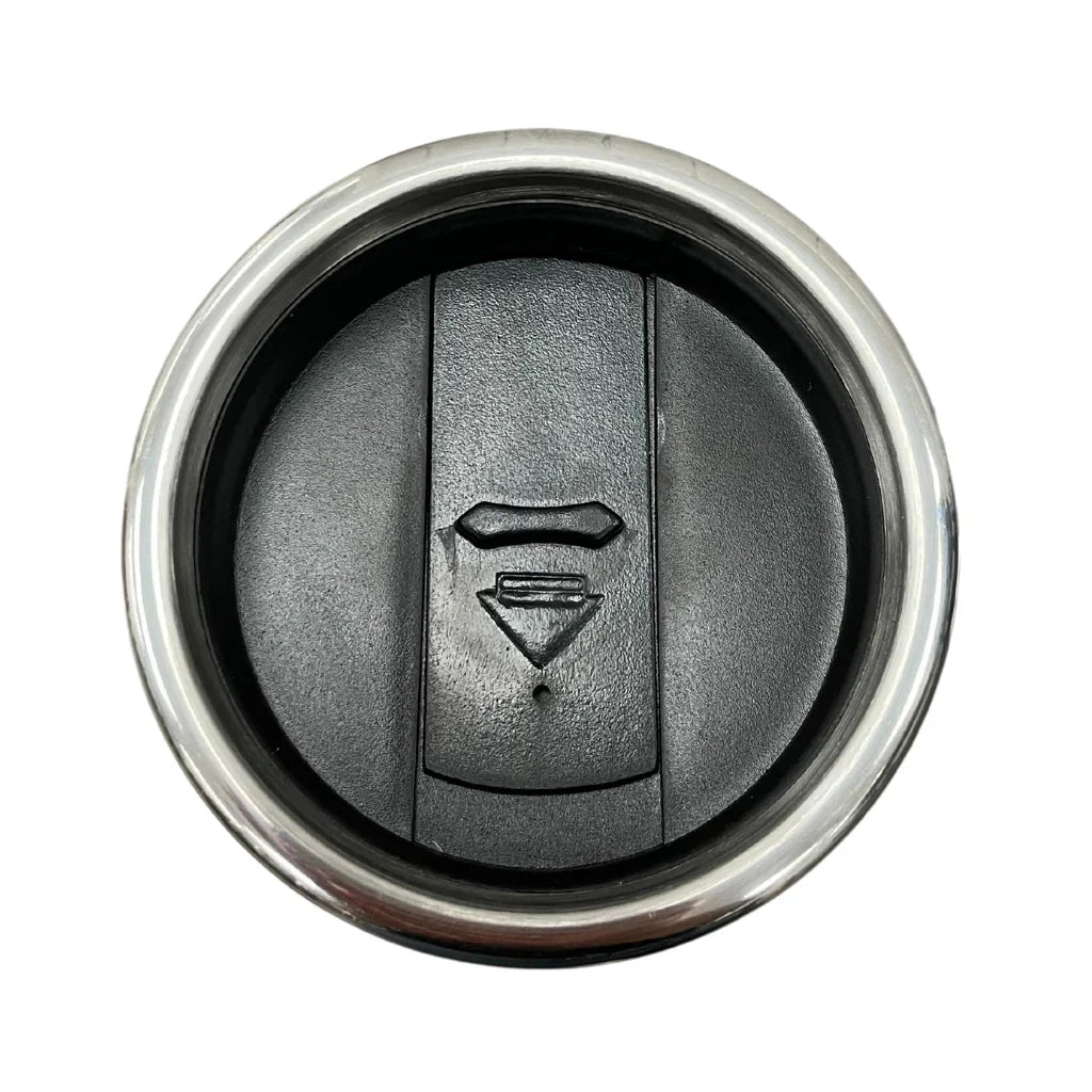 Stainless steel travel mug lid with black plastic cover, closed top view