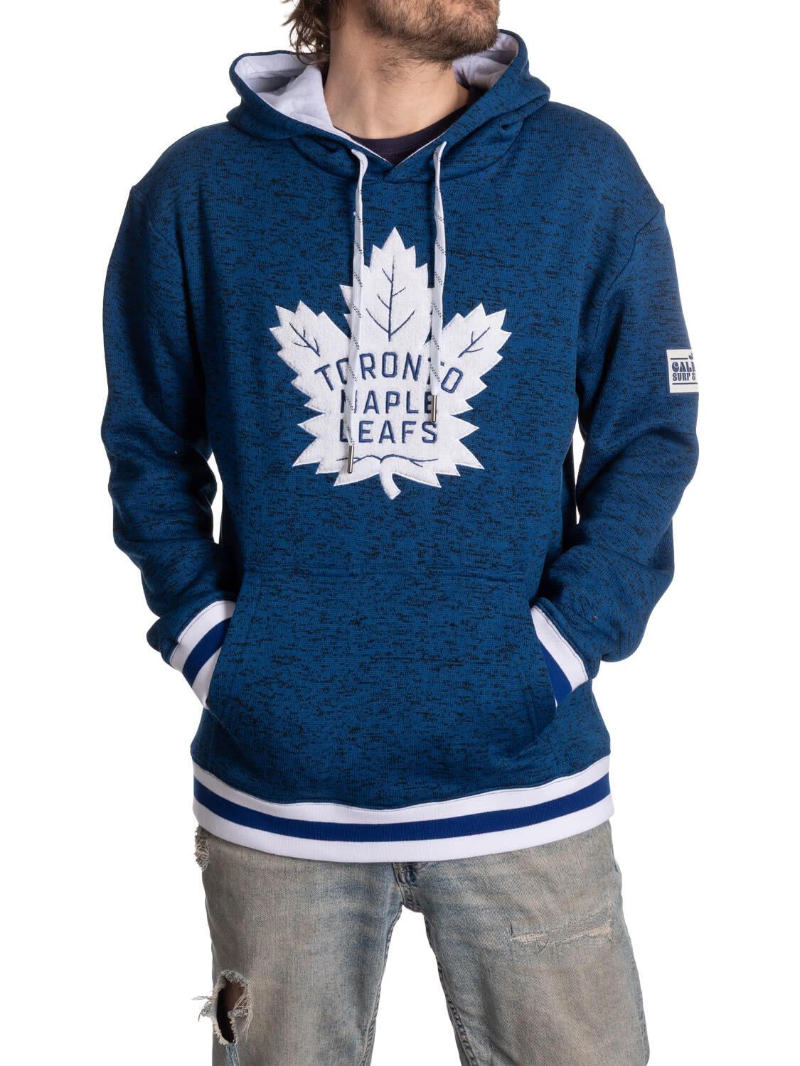 Man wearing navy Toronto Maple Leafs hoodie with white logo and distressed jeans