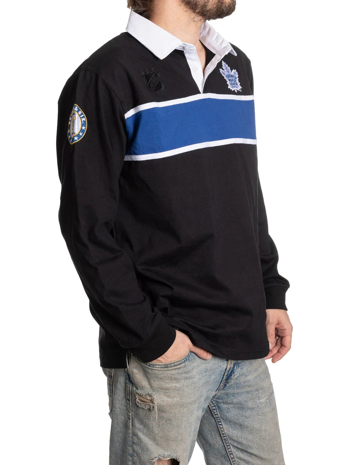 Man in black Toronto Maple Leafs rugby shirt with blue stripe, white collar, and ripped jeans