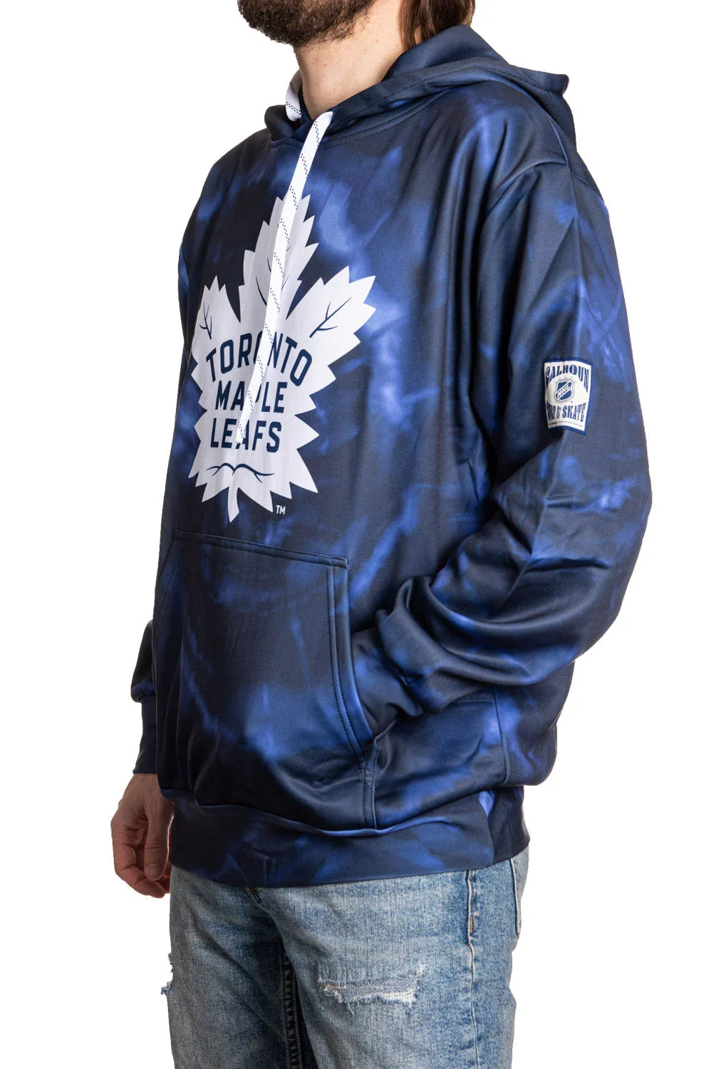 Toronto Maple Leafs blue tie-dye hoodie with team logo, worn by a person in jeans.