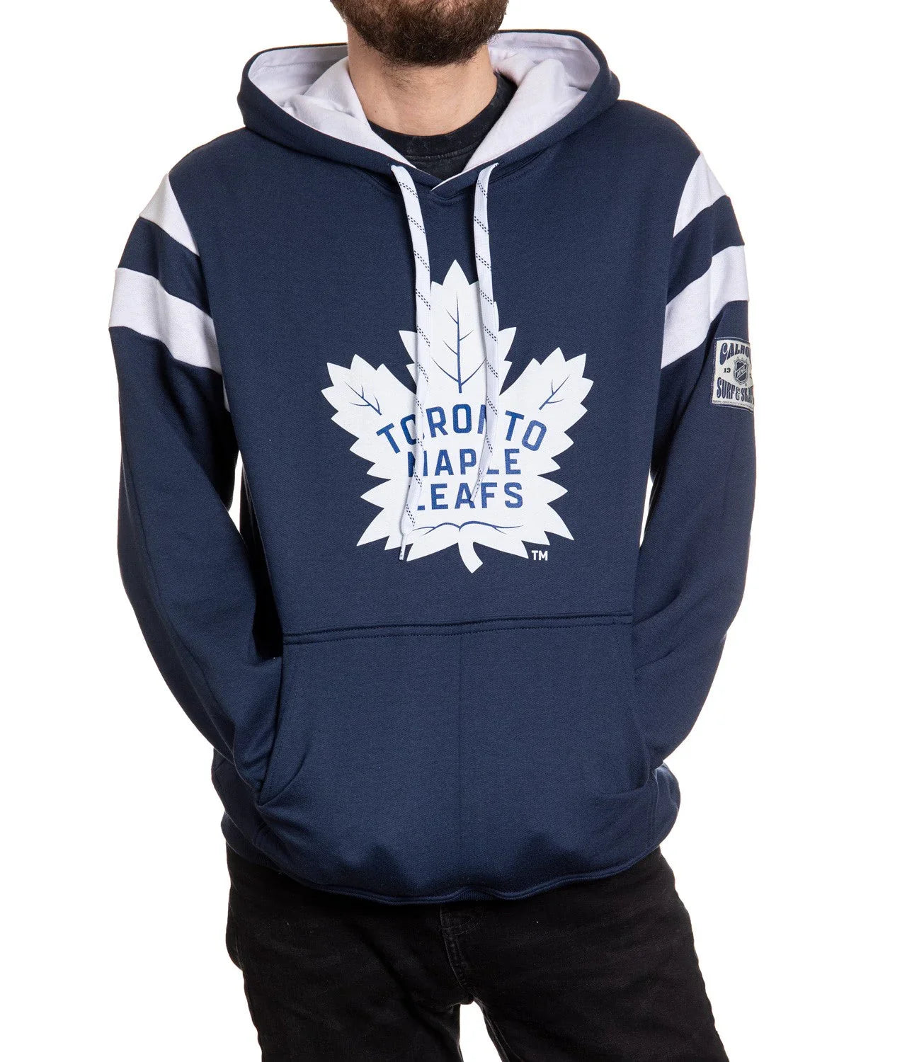 Man wearing navy blue Toronto Maple Leafs hoodie with white logo and stripes on sleeves