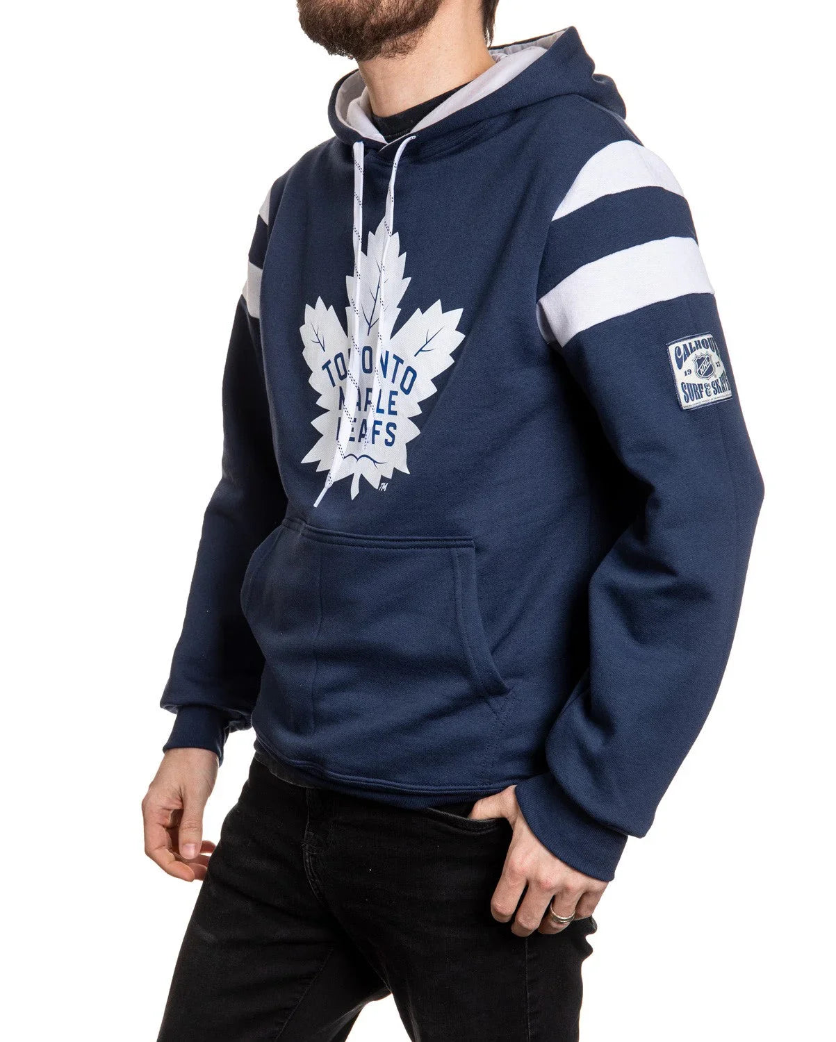 Man wearing navy Toronto Maple Leafs hoodie with white stripes and patch on sleeve