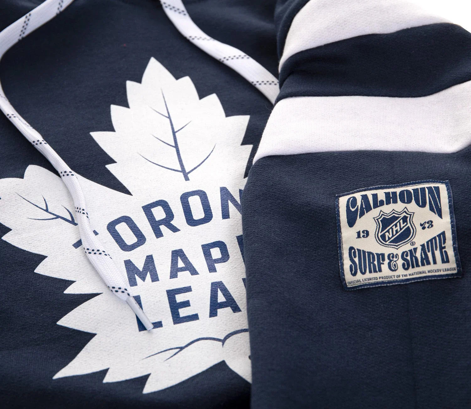 Toronto Maple Leafs hoodie with Calhoun Surf & Skate NHL patch on dark blue fabric