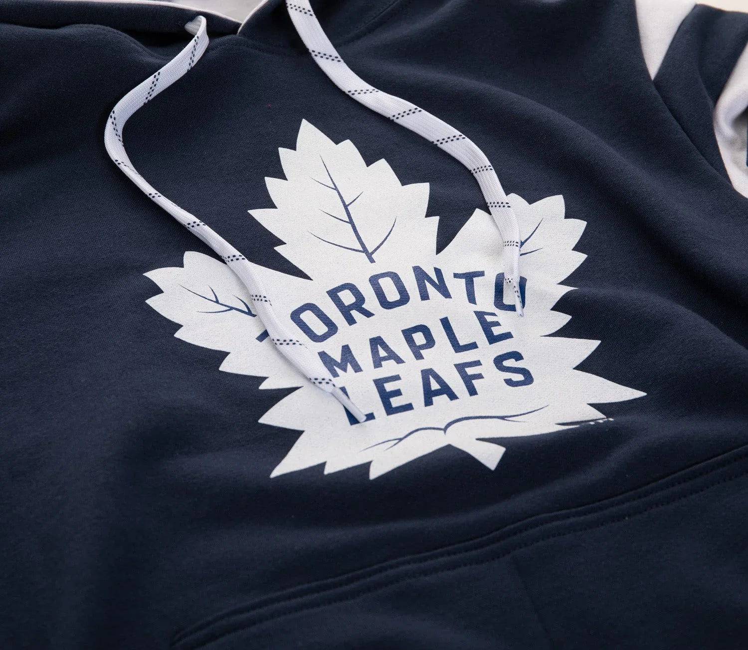 Toronto Maple Leafs logo on navy blue hoodie with white drawstrings