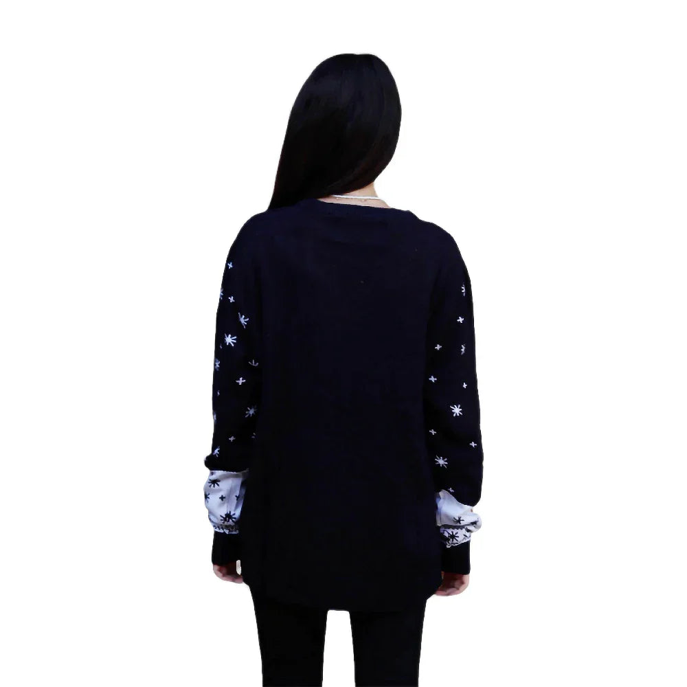 Back view of woman wearing black ugly Christmas sweater with white snowflake sleeves