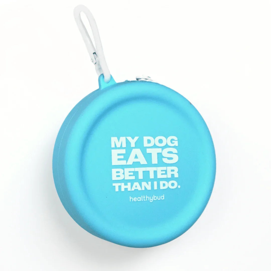 Blue dog treat pouch with white carabiner and 'My Dog Eats Better Than I Do' text.