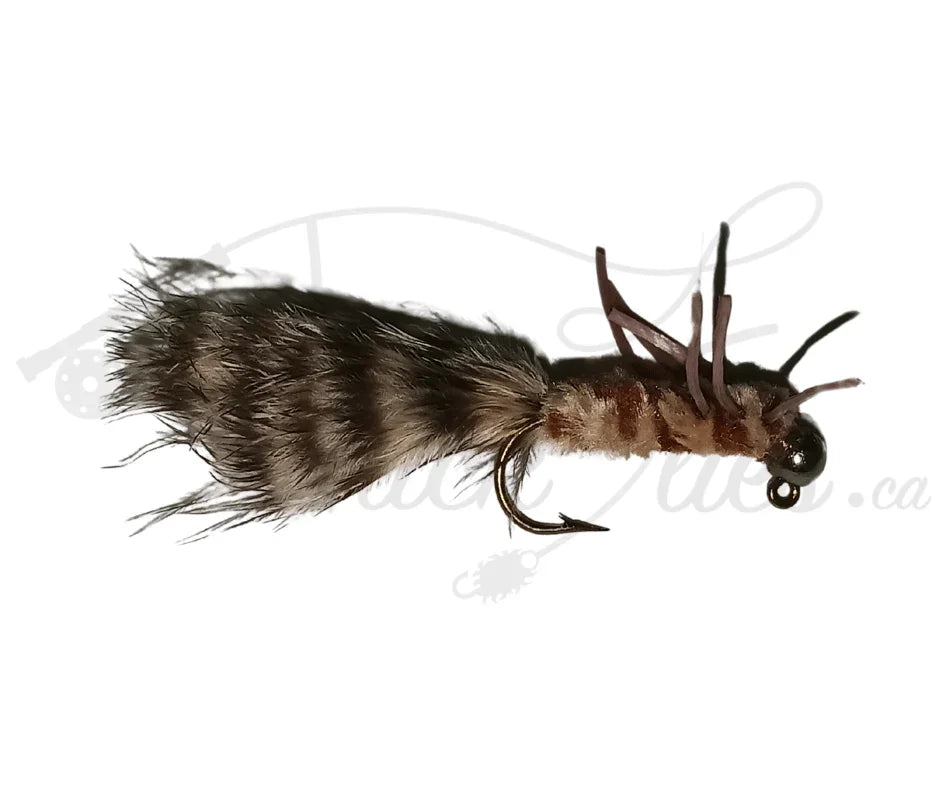 Tan and brown tungsten jighead fishing fly with fur tail and bead head on white background