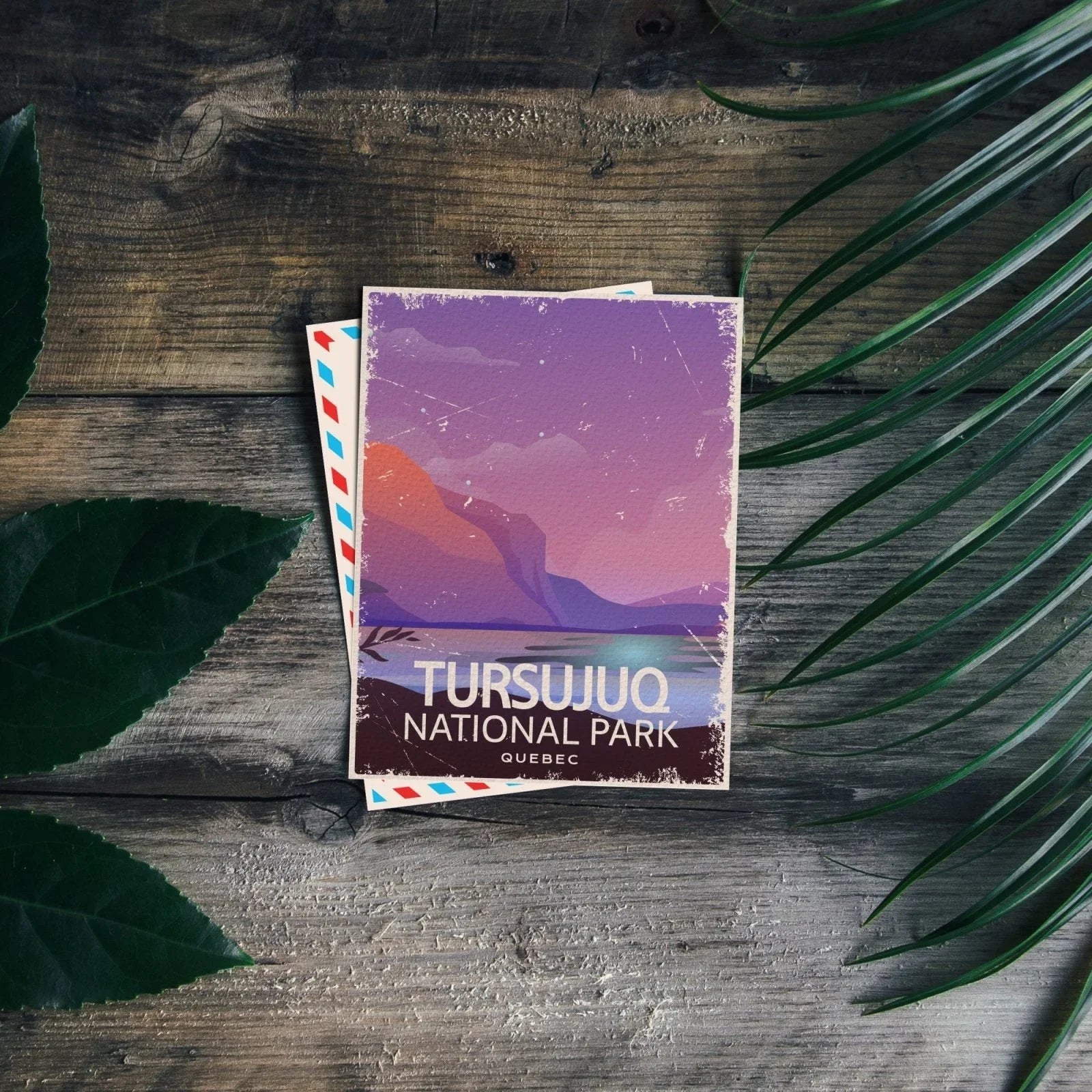 Tursujuq National Park Quebec postcard on rustic wooden table with green leaves