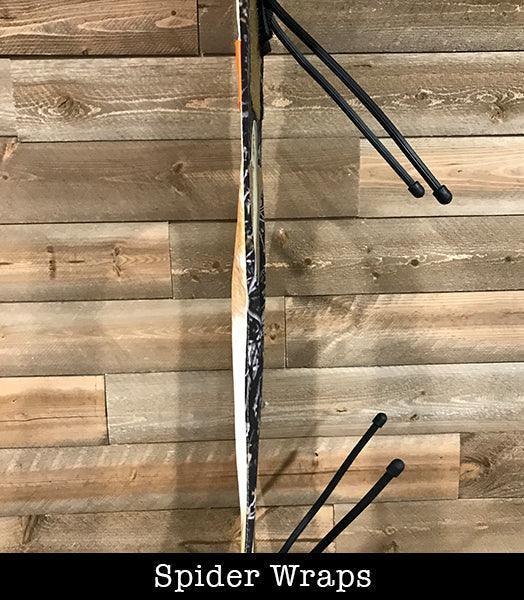 Spider Wraps weapon attachment on wood panel wall, hunting gear accessory