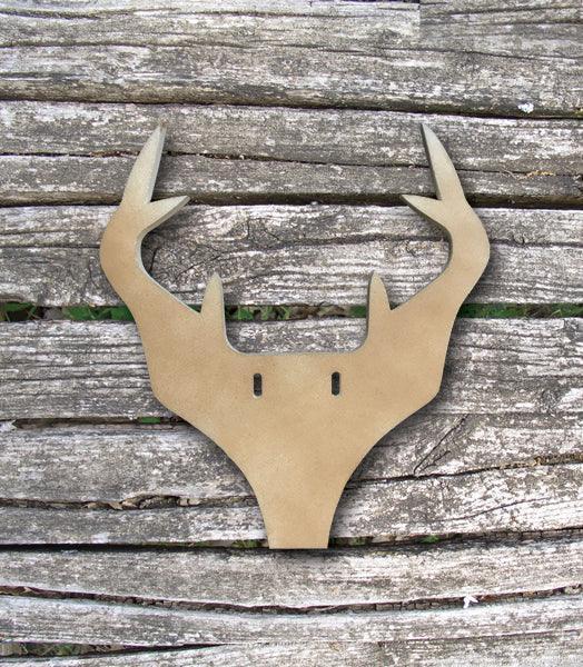 Brown antler-shaped wall decor on rustic wooden background