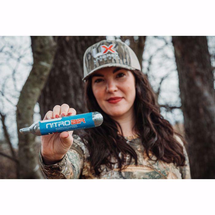 Woman outdoors holding Umarex NitroAir prefilled nitrogen cartridge