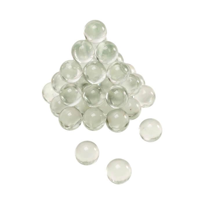 Pyramid stack of clear glass slingshot ammo balls on white background