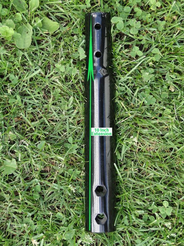 10 inch black metal extension tube with holes on green grass