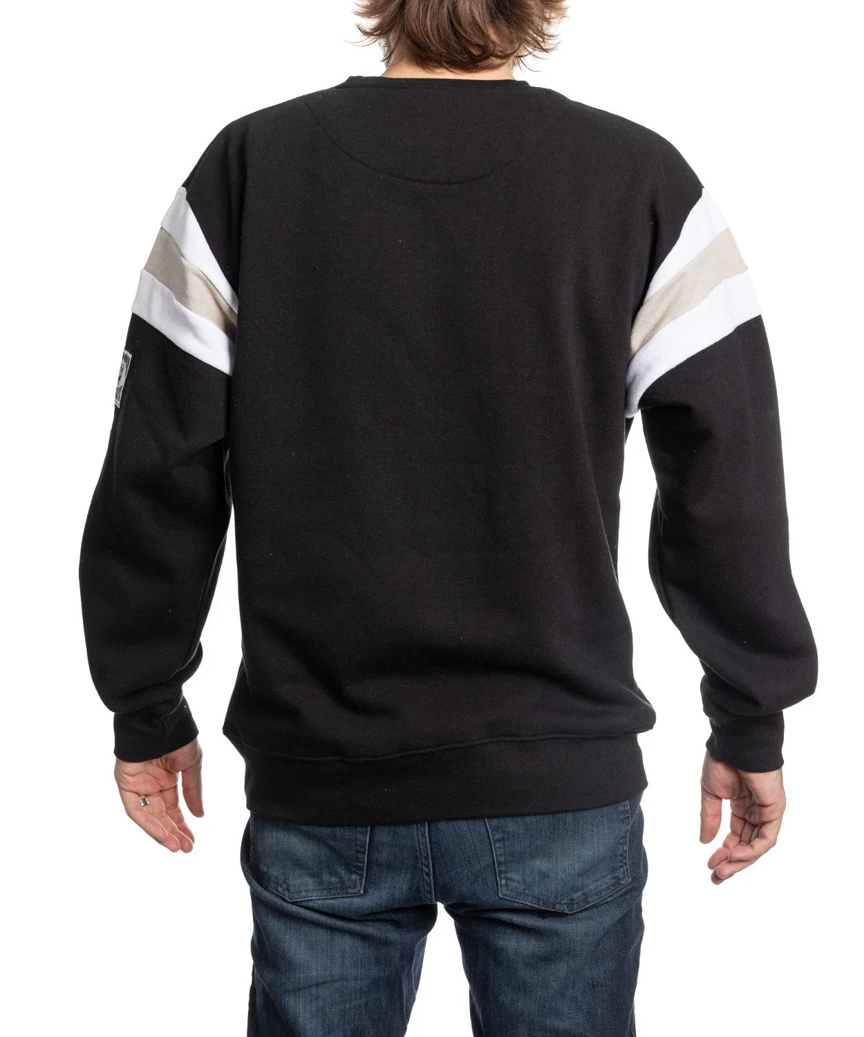 Back view of black varsity sweater with white and gray stripes, worn with blue jeans