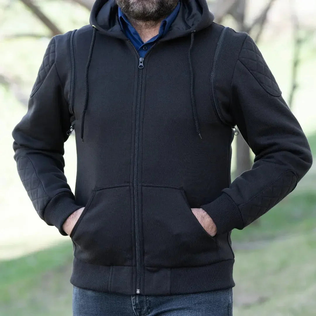 Man wearing black denim vest hoodie, zip-up front, quilted sleeves, outdoors