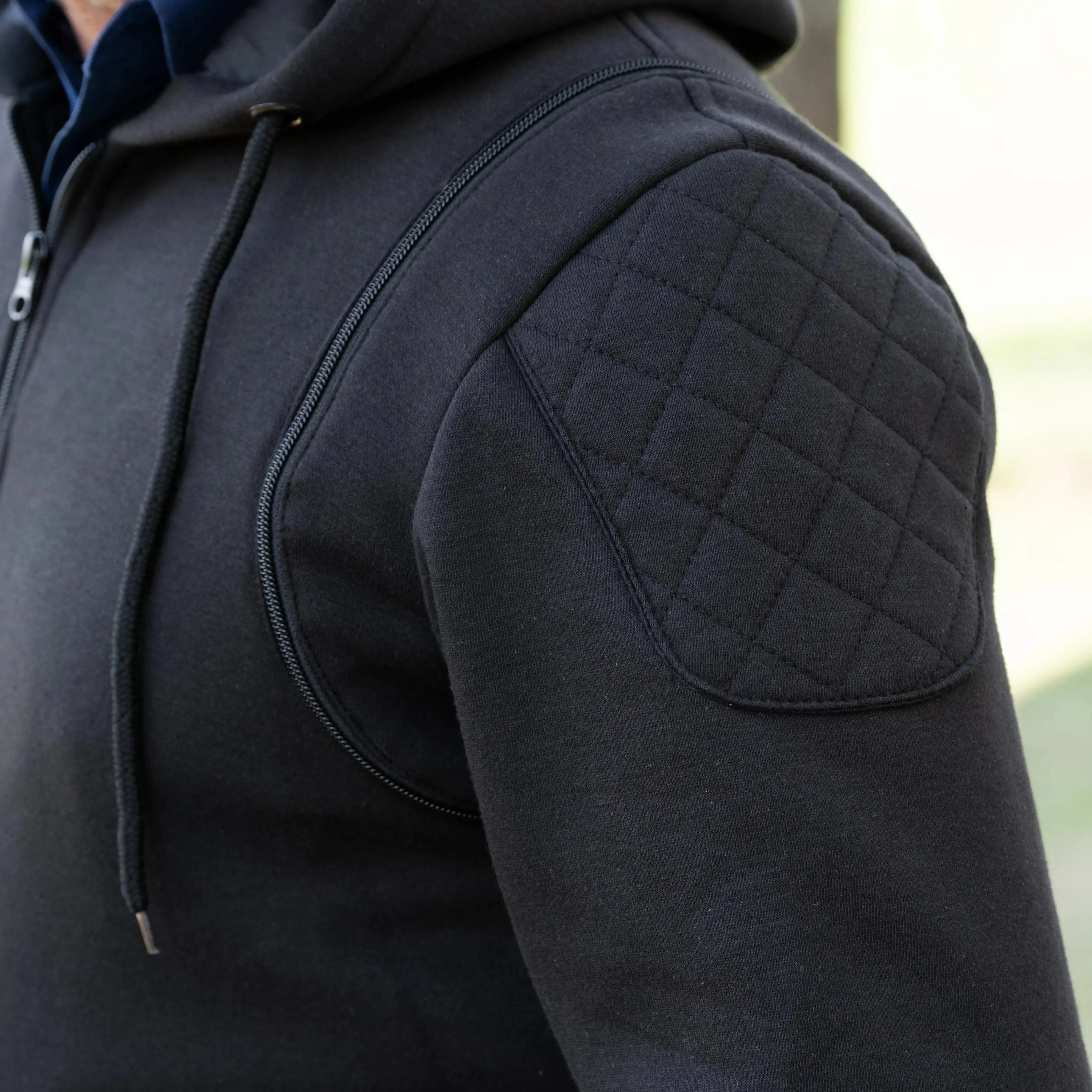 Black denim vest with hoodie, quilted shoulder panel, men's outerwear detail