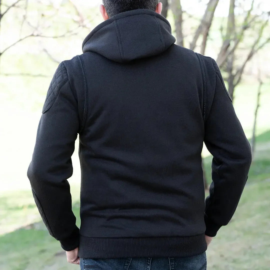 Man wearing black denim vest with hoodie outdoors, back view, casual men's fashion