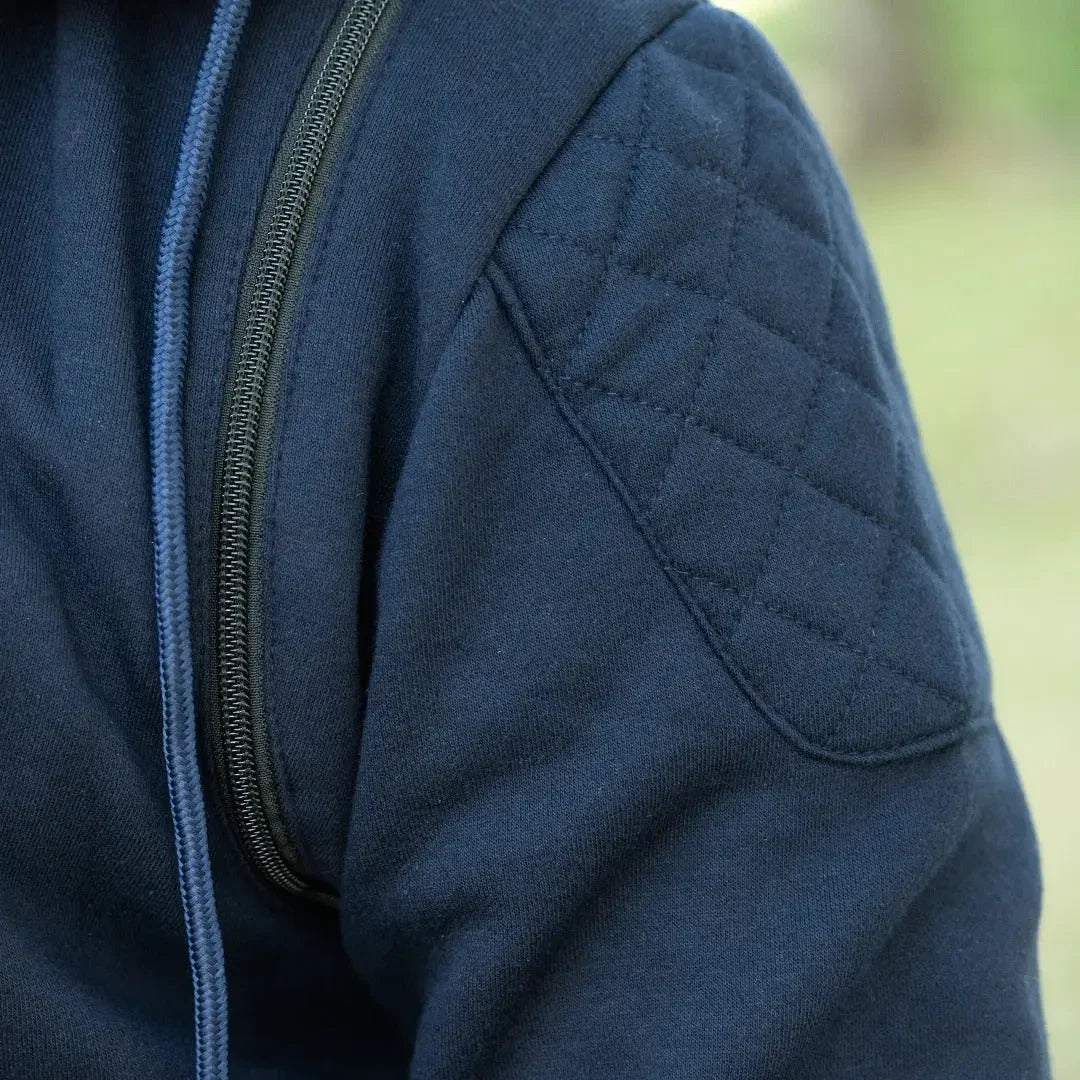 Close-up of navy quilted denim vest with hoodie and zipper, men's streetwear fashion