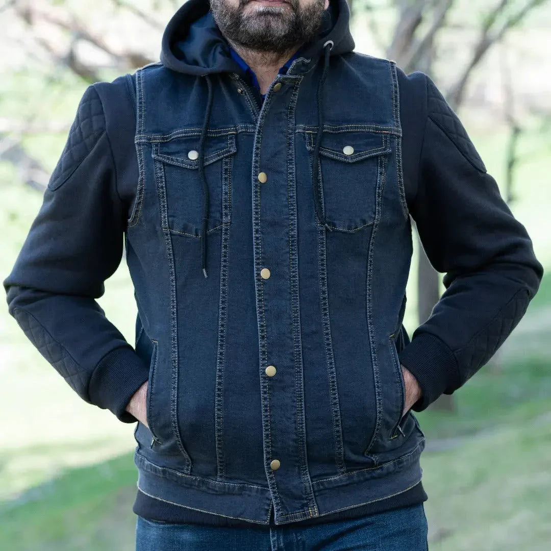 Man wearing versatile denim vest with hoodie and black sleeves outdoors