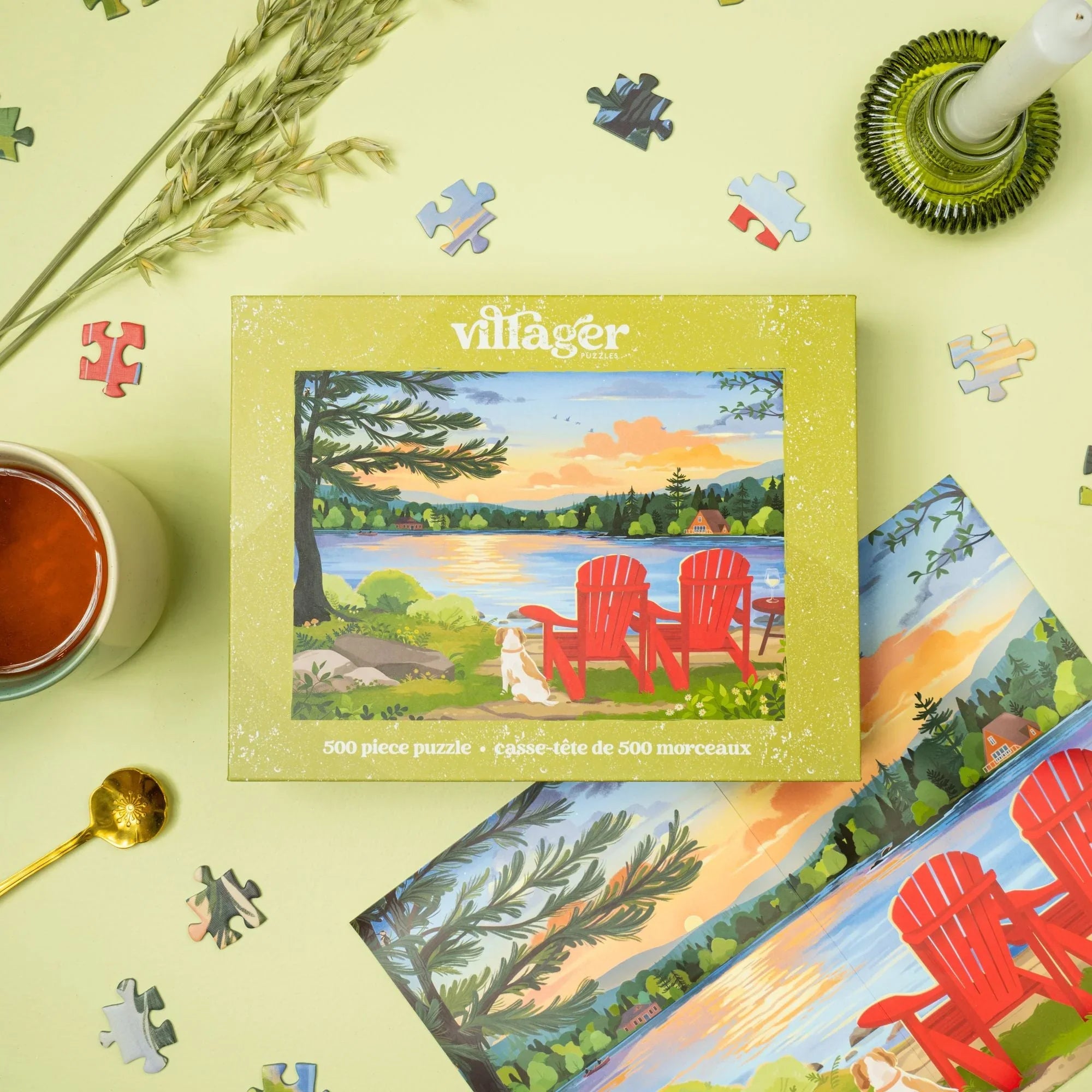 Villager 500 piece puzzle box with scenic lakeside view, red chairs, scattered puzzle pieces