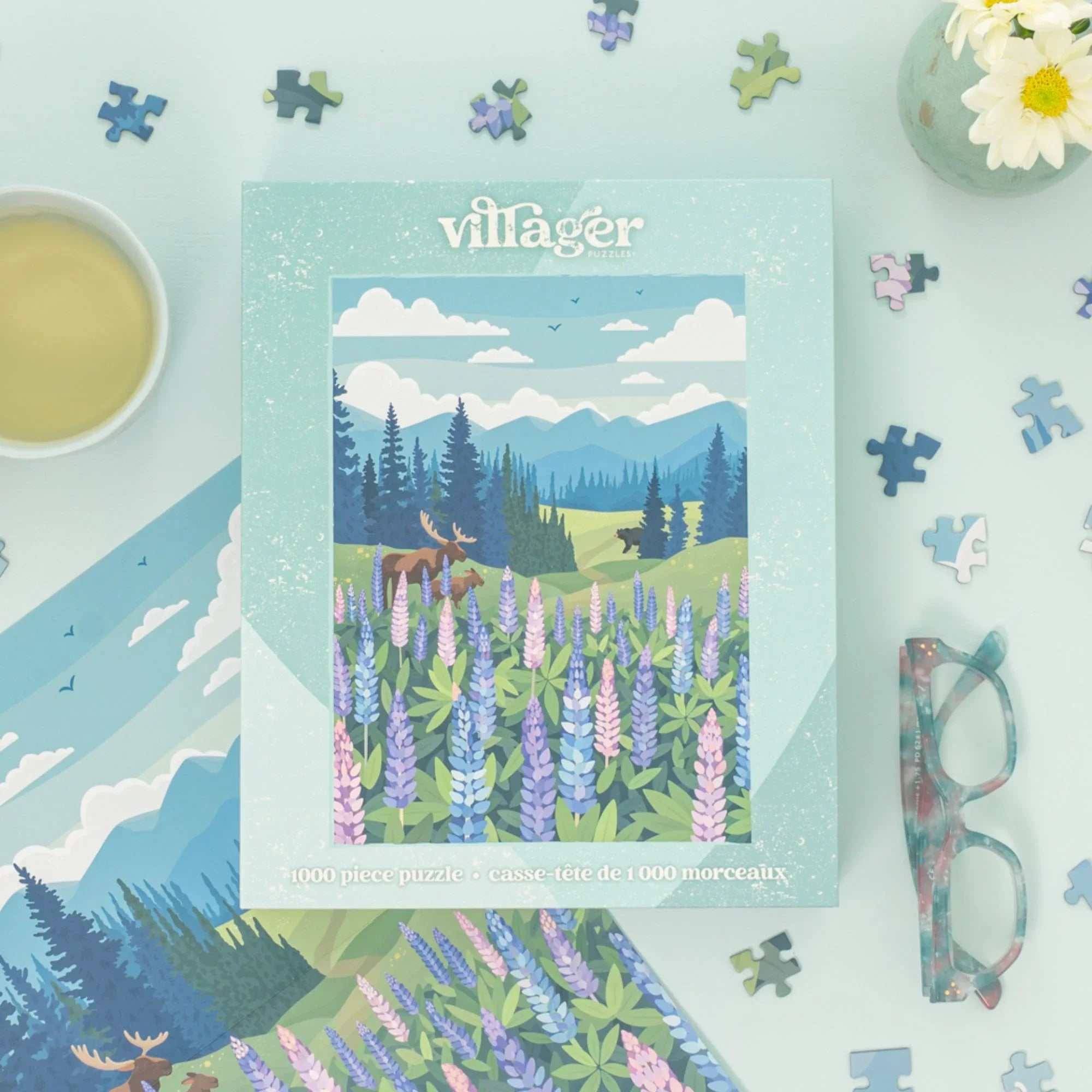 Villager Lupines Meadow puzzle box with wildflower scene, tea, eyeglasses, and scattered pieces