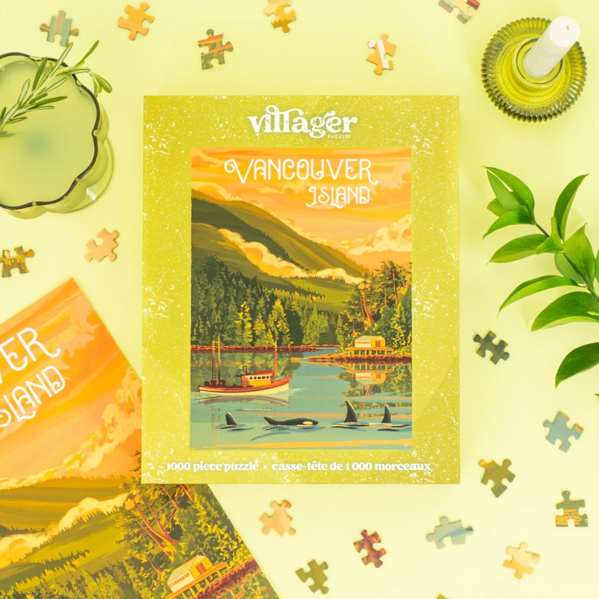 Vancouver Island puzzle box with coastal landscape, orcas, boat, and scattered puzzle pieces