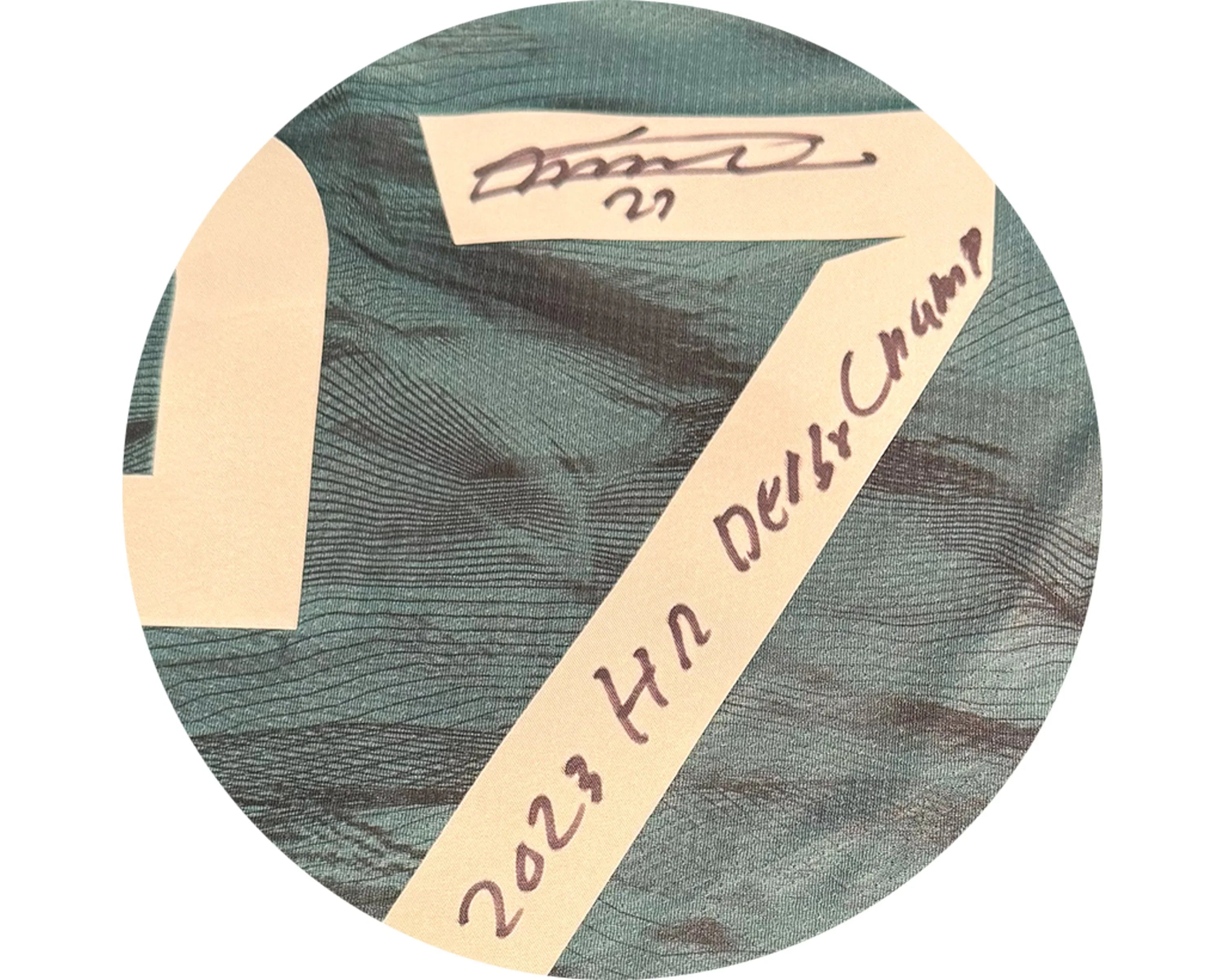 Closeup of signed sports jersey with 2023 HR Derby Champ handwritten in black ink
