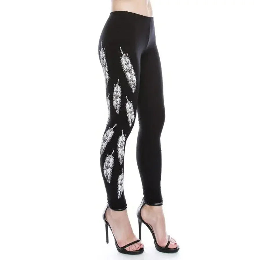 Black women's leggings with white feather print, side view, worn with high heels