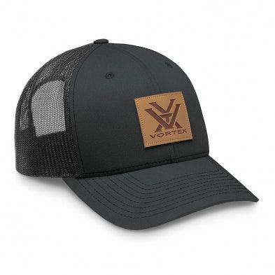 Black Vortex trucker hat with mesh back and brown logo patch on the front