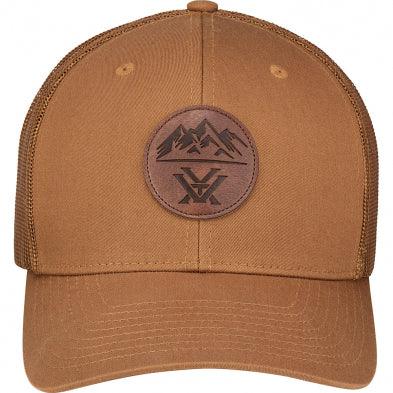 Brown trucker hat with mesh back and leather mountain patch on the front
