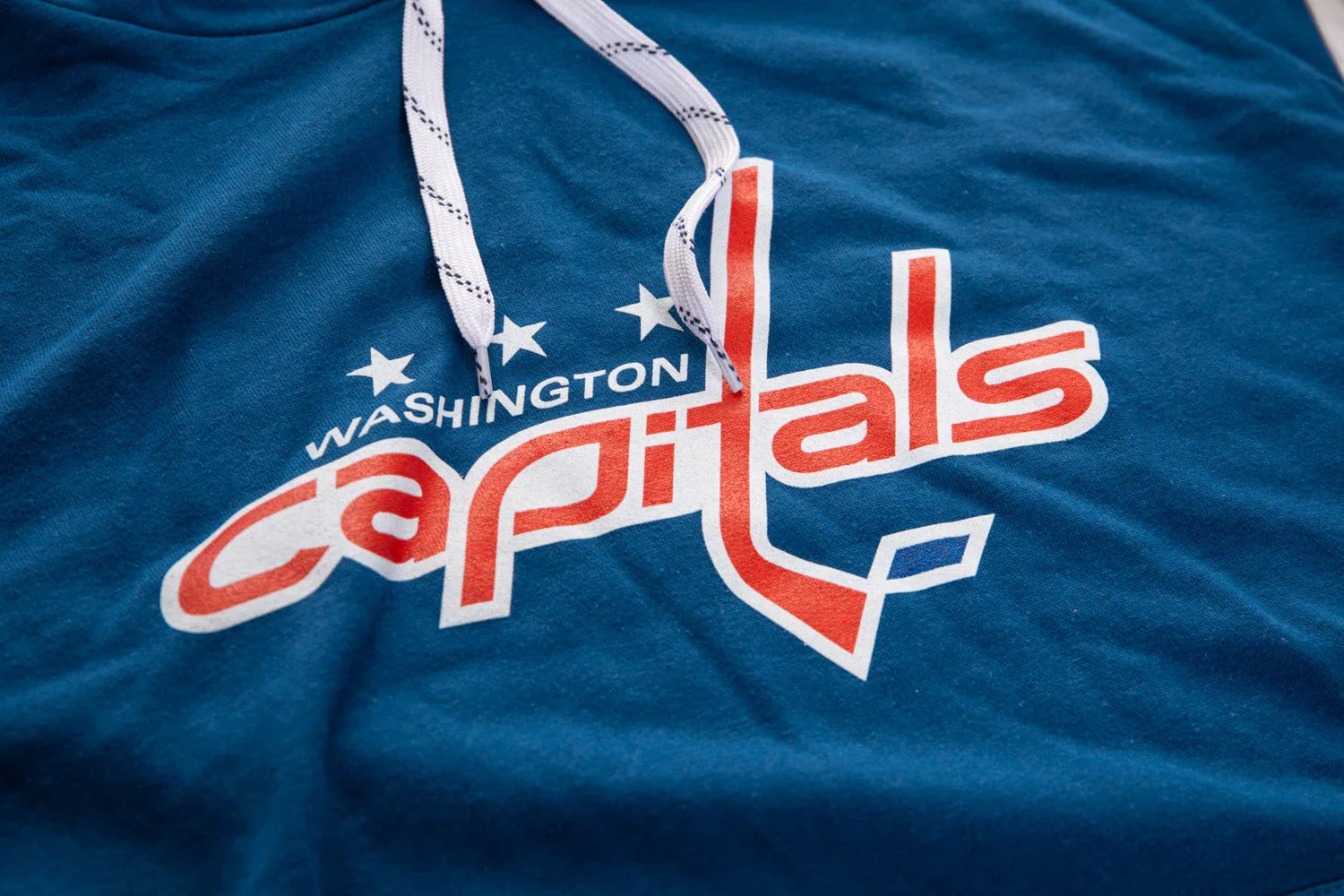 Washington Capitals blue varsity hoodie with red and white logo detail and drawstrings