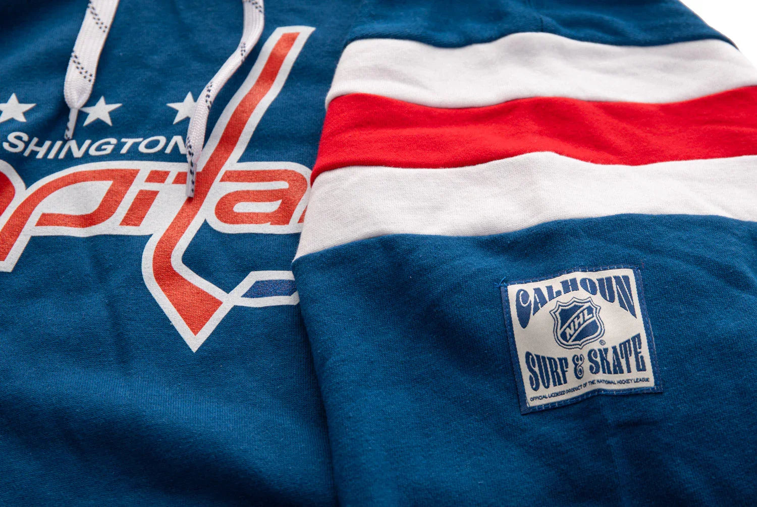 Washington Capitals blue varsity hoodie with red and white stripes and NHL Calhoun patch