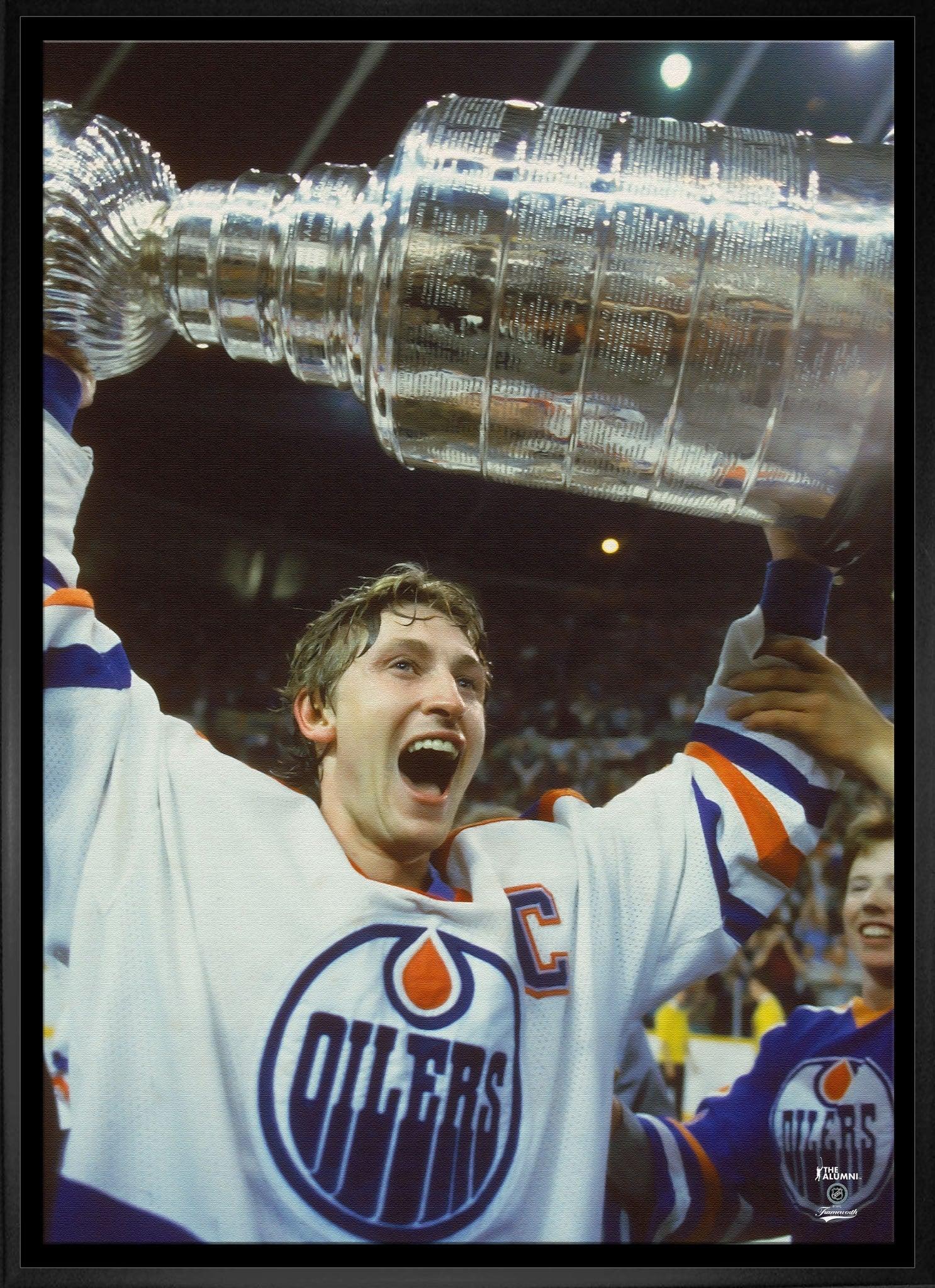 Edmonton Oilers hockey player lifting Stanley Cup trophy, celebrating victory on ice rink