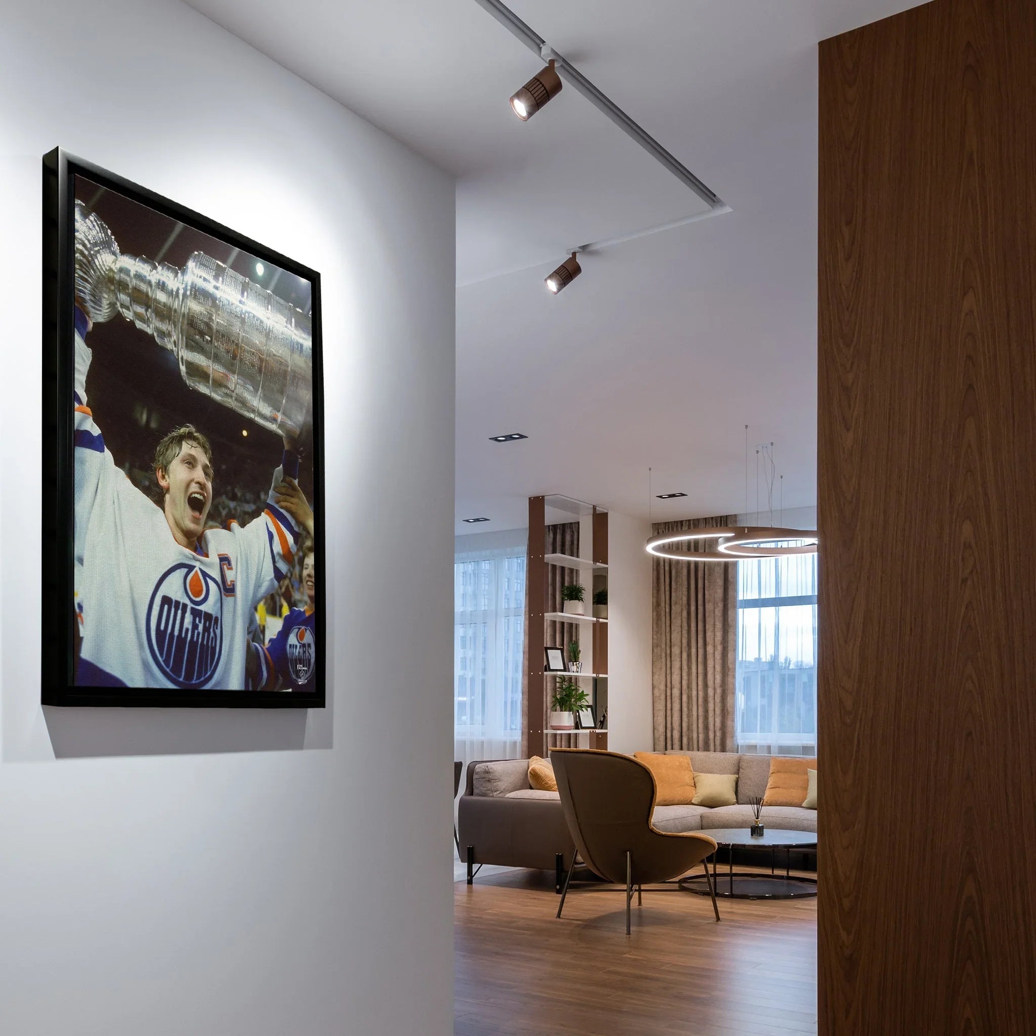 Modern living room with oilers hockey champion framed photo on white wall, stylish decor