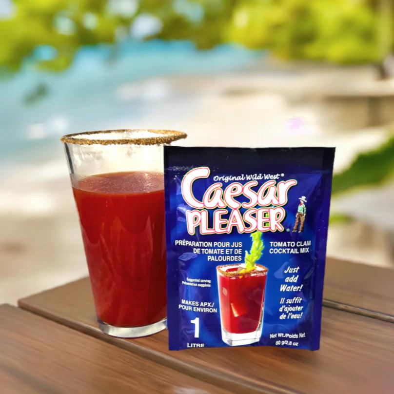 Caesar Pleaser tomato clam cocktail mix packet and glass on wooden table outdoors