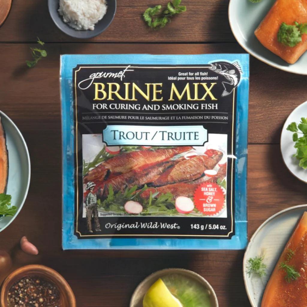 Gourmet trout brine mix for curing fish on wooden table with herbs and salmon fillets