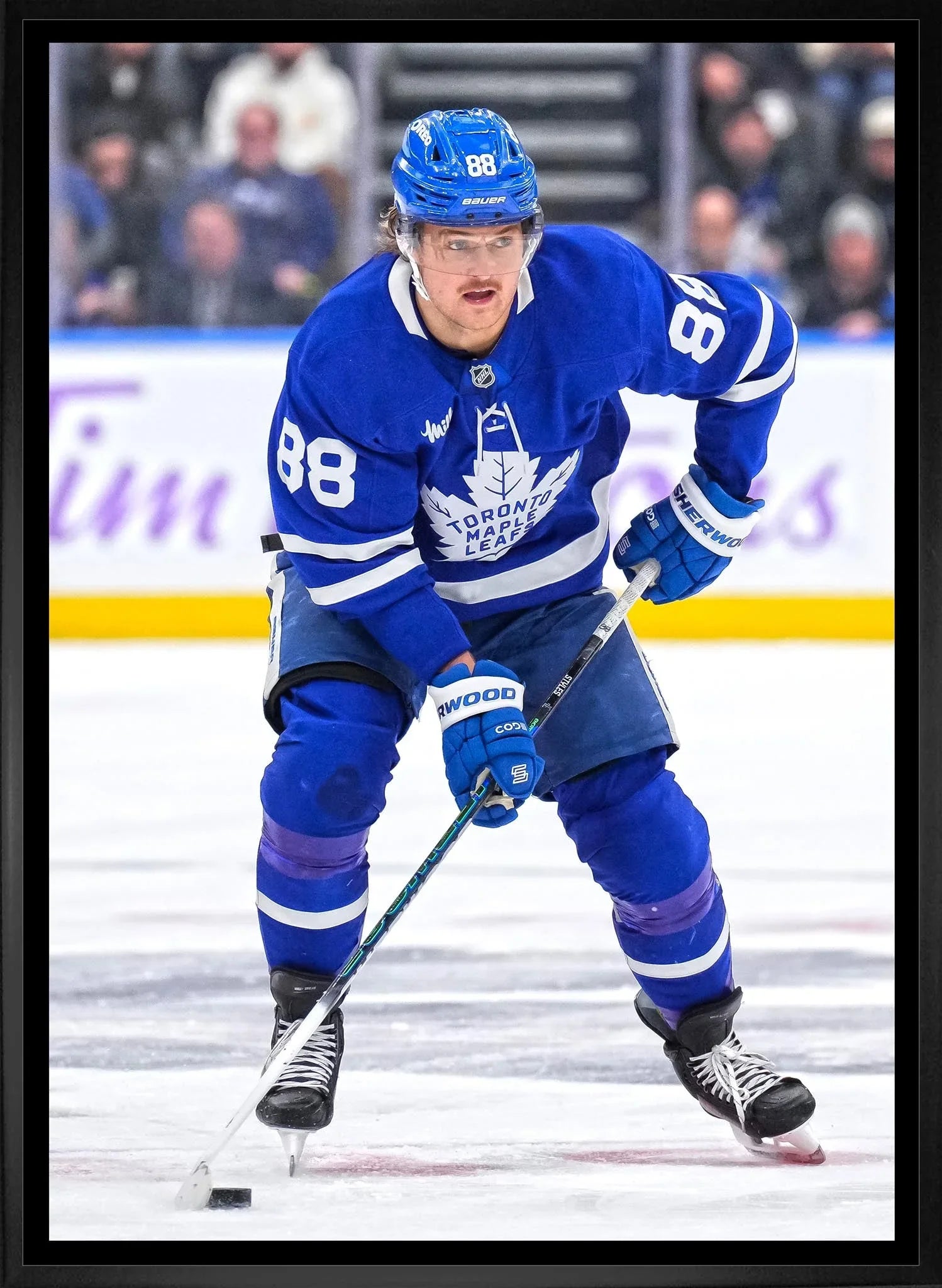 Toronto Maple Leafs ice hockey player in blue uniform with number 88 skating on rink